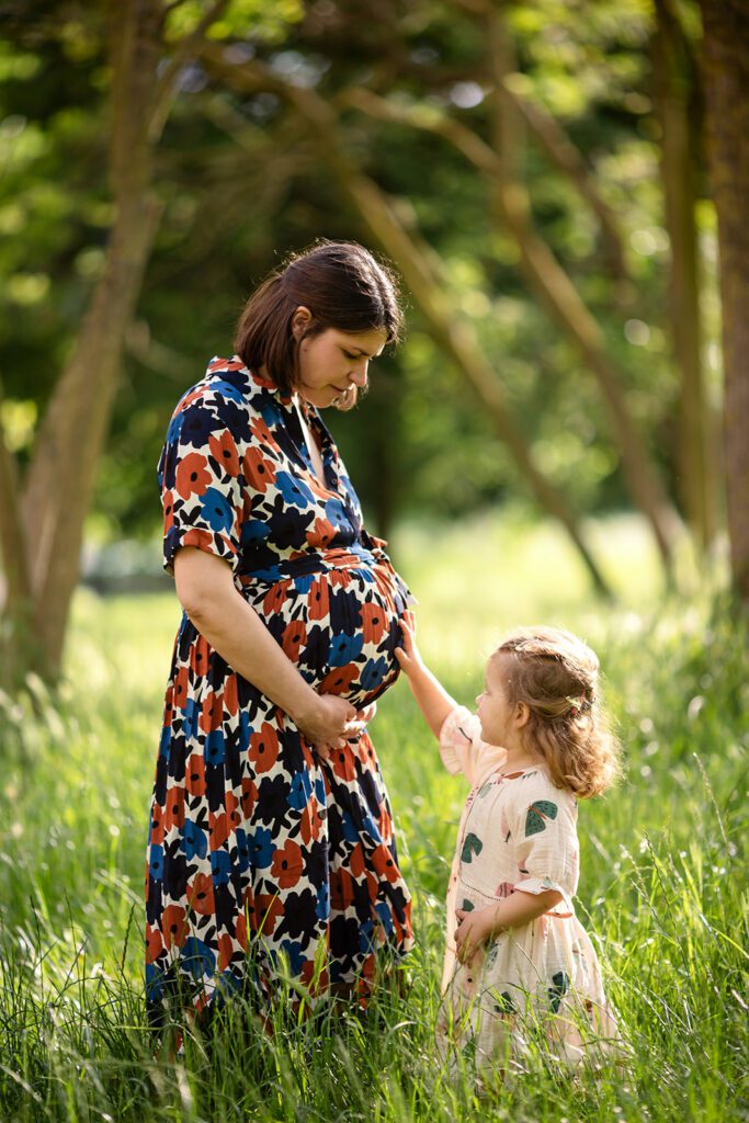 pregnant mum posing with her toddler for Outdoor maternity photos in Dublin