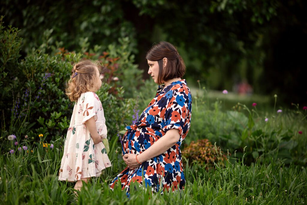 mum posing with her baby bump and toddler for Outdoor maternity photos in Dublin
