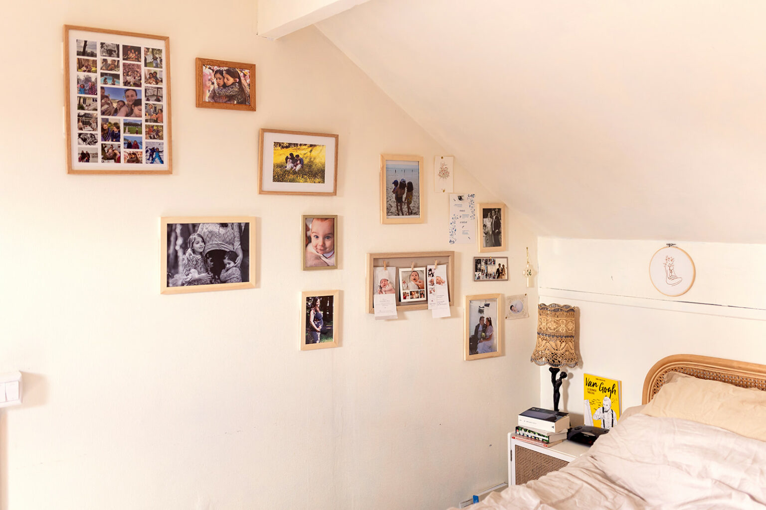 A collection of family photographs arranged on a bedroom wall